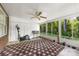 Light-filled sun room with large windows, tiled floors, and exercise equipment at 5302 Fairgrove Ln, Harrisburg, NC 28075