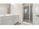 Beautiful bathroom with white cabinets, granite countertops, double sinks, and glass-enclosed shower at 5337 Orchid Bloom Dr, Indian Land, SC 29707