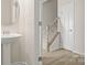 Powder room with a pedestal sink, decorative mirror, and modern fixtures at 5337 Orchid Bloom Dr, Indian Land, SC 29707