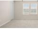 Neutral bedroom featuring plush carpeting and natural light from the windows at 5337 Orchid Bloom Dr, Indian Land, SC 29707