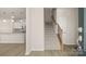 Bright entryway featuring staircase, wood floors, and a view of the modern kitchen at 5337 Orchid Bloom Dr, Indian Land, SC 29707
