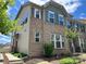 Beautiful townhome exterior with brick and siding, complemented by blue shutters and a well-manicured lawn at 5337 Orchid Bloom Dr, Indian Land, SC 29707