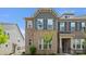 Charming townhouse exterior featuring brick facade, blue shutters, and tidy landscaping at 5337 Orchid Bloom Dr, Indian Land, SC 29707