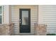 Inviting front door with brick accents and neutral siding, offering a warm welcome at 5337 Orchid Bloom Dr, Indian Land, SC 29707