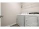Bright laundry area with modern white washer and dryer, and convenient wire shelving at 5337 Orchid Bloom Dr, Indian Land, SC 29707