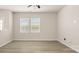 Bright, airy living room filled with natural light through large windows and light colored floors at 5337 Orchid Bloom Dr, Indian Land, SC 29707