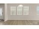 Bright living area with wood floors and large windows, creating an inviting space at 5337 Orchid Bloom Dr, Indian Land, SC 29707