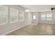Open living area featuring wood floors, neutral walls, and ample natural light from windows at 5337 Orchid Bloom Dr, Indian Land, SC 29707