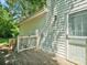 Side view of a home with a small wooden deck, a small section of grass, and a wood fence at 5828 Wilora Lake Rd, Charlotte, NC 28212