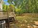 Wooden deck and fenced yard with mature trees for outdoor enjoyment and privacy at 5828 Wilora Lake Rd, Charlotte, NC 28212