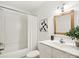 Bright bathroom with a shower and tub, framed mirror, and vanity with a white sink at 5828 Wilora Lake Rd, Charlotte, NC 28212