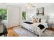 Light-filled bedroom with hardwood floors, a patterned rug, and a ceiling fan at 5828 Wilora Lake Rd, Charlotte, NC 28212