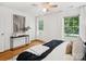 Bedroom featuring hardwood floors, a ceiling fan, two windows, and natural light at 5828 Wilora Lake Rd, Charlotte, NC 28212