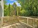 Wooden deck overlooking a lush, green backyard with mature trees, with a wood fence at 5828 Wilora Lake Rd, Charlotte, NC 28212