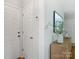 The front hallway features modern decor and white paneled doors for an entryway aesthetic that is light and airy at 5828 Wilora Lake Rd, Charlotte, NC 28212