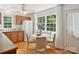 Well-equipped kitchen with wooden cabinets, white appliances, and a breakfast nook near a bright window at 5828 Wilora Lake Rd, Charlotte, NC 28212