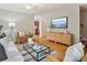 Inviting living room with hardwood floors, stylish furniture, and a view into the kitchen, perfect for entertaining at 5828 Wilora Lake Rd, Charlotte, NC 28212