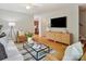 Inviting living room with hardwood floors, a stylish glass coffee table, and a comfortable seating area at 5828 Wilora Lake Rd, Charlotte, NC 28212