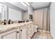 Bathroom with double sinks, neutral granite countertop and shower with curtain at 5980 Cougar Ln, Charlotte, NC 28269