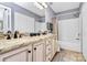 Bathroom with double sinks, neutral granite countertop and shower with tub at 5980 Cougar Ln, Charlotte, NC 28269
