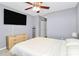 Cozy bedroom featuring a neutral color scheme, ceiling fan, and closet space at 5980 Cougar Ln, Charlotte, NC 28269