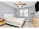 Light and airy bedroom with a cozy bed, modern decor, and a ceiling fan at 5980 Cougar Ln, Charlotte, NC 28269