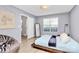 Comfortable bedroom with a wooden frame bed, modern décor, a window, and an attached closet at 5980 Cougar Ln, Charlotte, NC 28269