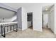 Spare bedroom featuring a closet, natural light, and hallway access to a bathroom at 5980 Cougar Ln, Charlotte, NC 28269