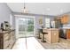 Breakfast nook with bar seating and sliding door to back, tile floor at 5980 Cougar Ln, Charlotte, NC 28269