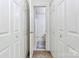 Hallway featuring access to a bathroom showcasing clean lines and a functional layout at 5980 Cougar Ln, Charlotte, NC 28269