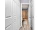 Hallway with multiple storage closets, view of bathroom with shower curtain at 5980 Cougar Ln, Charlotte, NC 28269