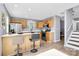 Open kitchen design featuring a breakfast bar, wood cabinets, stainless steel appliances and plenty of natural light at 5980 Cougar Ln, Charlotte, NC 28269