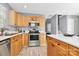 Well-maintained kitchen featuring stainless steel appliances and ample wood cabinets at 5980 Cougar Ln, Charlotte, NC 28269