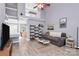 Bright living room featuring wood-look tile, vaulted ceiling, and open floor plan at 5980 Cougar Ln, Charlotte, NC 28269