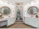 Elegant bathroom with dual vanities, large mirrors, and a neutral color palette for a serene ambiance at 610 Hampshire Hill Rd, Matthews, NC 28105