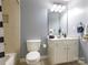 Neutral bathroom featuring a shower-tub combo, toilet, vanity, sink, and light gray walls at 610 Hampshire Hill Rd, Matthews, NC 28105
