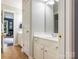 Bathroom featuring double sinks, white cabinets, and bronze fixtures in a bright, tiled space at 610 Hampshire Hill Rd, Matthews, NC 28105