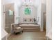 Luxurious bathroom with a soaking tub, walk-in shower, and large window offering natural light and views at 610 Hampshire Hill Rd, Matthews, NC 28105