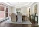 Elegant dining room with a chandelier, tray ceiling, and large windows at 610 Hampshire Hill Rd, Matthews, NC 28105