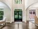 Grand foyer with high ceilings, a dark hardwood floor, and a statement front door at 610 Hampshire Hill Rd, Matthews, NC 28105