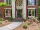Inviting front entry with brick steps, black double doors, and manicured landscaping at 610 Hampshire Hill Rd, Matthews, NC 28105