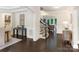 Hallway with a staircase and views into other rooms, showcasing the home's open layout at 610 Hampshire Hill Rd, Matthews, NC 28105