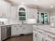 Bright kitchen featuring white cabinets, stainless steel appliances, marble countertops and island at 610 Hampshire Hill Rd, Matthews, NC 28105
