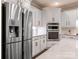 Bright kitchen featuring stainless steel refrigerator, white cabinets, and stainless steel microwave and oven at 610 Hampshire Hill Rd, Matthews, NC 28105