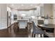 Bright, open kitchen features white cabinets, stainless steel appliances, large island with bar seating, and dark wood floors at 610 Hampshire Hill Rd, Matthews, NC 28105