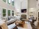 Spacious living room featuring a stone fireplace, built-in shelving, and ample natural light at 610 Hampshire Hill Rd, Matthews, NC 28105