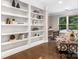Charming office space with built-in bookshelves, hardwood flooring, and a cozy chair near the window at 610 Hampshire Hill Rd, Matthews, NC 28105