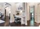 Hallway nook with built-in desk, overhead cabinets, and a view into the living room at 610 Hampshire Hill Rd, Matthews, NC 28105