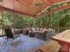 Screened-in porch featuring wood ceiling, furniture, ceiling fan, and a large window with great backyard views at 610 Hampshire Hill Rd, Matthews, NC 28105