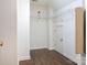 Spacious walk-in closet with hardwood floors and ample shelving for organization and storage at 610 Hampshire Hill Rd, Matthews, NC 28105